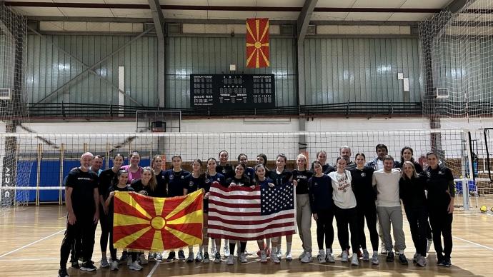 the Trinity delegation and North Macedonian host representatives posed for a photo in a gym, holding up a USA flag and a North Macedonian flag